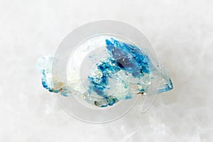 sample of raw euclase crystal on white marble