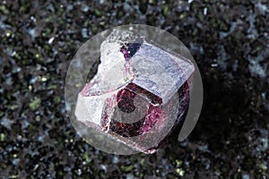 sample of raw rhodolite pyrope crystal on black