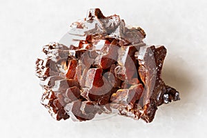 sample of raw vanadinite mineral on white marble