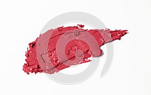 A sample of red lipstick is isolated on a white background. Texture of lipstick.