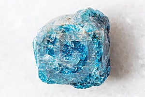 sample of rough blue apatite rock on white