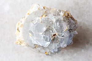 sample of rough celestine rock on white marble