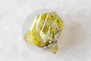 sample of rough chrysoberyl mineral on white
