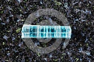 sample of rough indigolite crystal on black