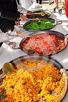 Sample and tasting of various types of Valencian paellas, a traditional Spanish dish for tourists photo