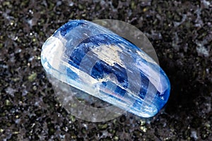 sample of tumbled blue kyanite gemstone on black