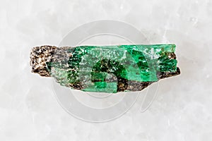 sample of unworked emerald crystal on white