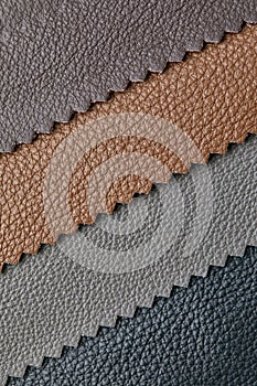 Samples of beige, brown, gray black leather. Leather crafts and craftwork. View from above.