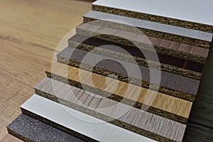 Samples of fibreboard panels with wood texture. Laminated CPD. Chipboard PVC edge. Wooden furniture CMD and MDF