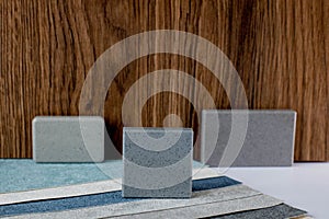 samples of finishing materials, close-up view, including various wooden laminates, interior wallpaper, gray artificial stone