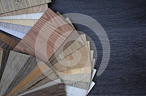 Samples of laminate and vinyl floor tile on wooden Background wood texture floor oak tile, maple tile, chestnut tile, walnut tile,