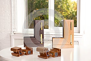 Samples of modern window profiles on table indoors.