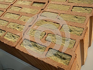 Samples of red hollow bricks with mineral wool insulation