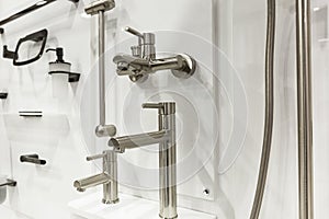 Samples of taps in the store. Large selection of plumbing. Construction, design and repair