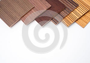 Samples of veneer wood on white background. interior design select material for idea.Hand holding veneer wood.