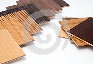 Samples of veneer wood on white background. interior design select material for idea.Hand holding veneer wood.