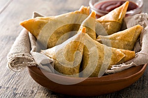 Samsa or samosas with meat and vegetables on wooden table. Traditional Indian food