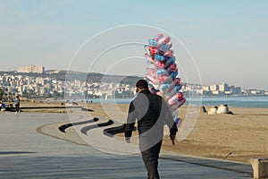 Samsun,Turkey - November 27, 2022 Man selling cotton candy on beach