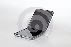 Samsung Galaxy Z Flip on a white background. New smartphone with a folding screen close-up