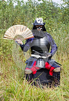 Samurai in armor with fan