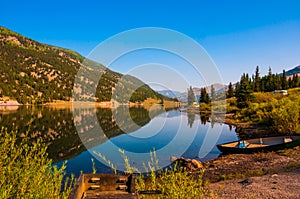 San Cristobal Lake reflections in the water on a nice sunrise morning alpine glow tranquil morning with canoe