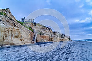 San Diego California beach with mountain houses overlooking ocean and cloudy sky