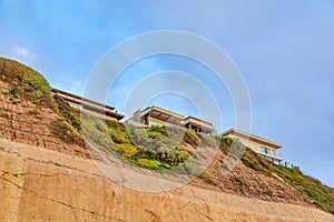 San Diego California mountain with homes against blue sky and clouds background