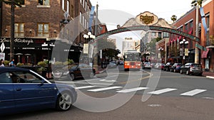 SAN DIEGO, CALIFORNIA USA - 30 JAN 2020: Gaslamp Quarter historic entrance arch sign on 5th avenue. Orange iconic retro trolley,