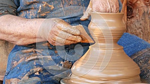 SAN DIEGO, CALIFORNIA USA - 5 JAN 2020: Potter working in mexican Oldtown, raw clay on pottery wheel. Man`s hands, ceramist in