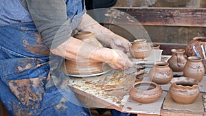 SAN DIEGO, CALIFORNIA USA - 5 JAN 2020: Potter working in mexican Oldtown, raw clay on pottery wheel. Man`s hands, ceramist in