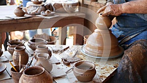 SAN DIEGO, CALIFORNIA USA - 5 JAN 2020: Potter working in mexican Oldtown, raw clay on pottery wheel. Man`s hands, ceramist in