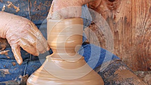 SAN DIEGO, CALIFORNIA USA - 5 JAN 2020: Potter working in mexican Oldtown, raw clay on pottery wheel. Man`s hands, ceramist in