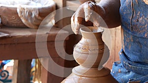 SAN DIEGO, CALIFORNIA USA - 5 JAN 2020: Potter working in mexican Oldtown, raw clay on pottery wheel. Man`s hands, ceramist in