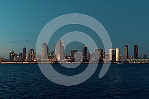 San diego city skyline with ocean in front of the buildings at sunset