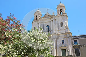 San Francesco d`Assisi all`Immacolata church with selective focus on flowered trees, Catania, Sicily, Italy