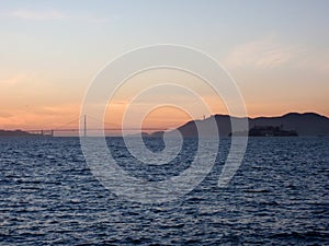 San Francisco city skyline, Golden Gate Bridge, and Alcatraz Island at dusk