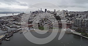 San Francisco Cityscape and Fisherman`s Wharf in Background. Cloudy Day. Aquatic Park Pier , Cove and Municipal Pier in San