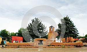 San Francisco de Asis Mission Church in Taos New Mexico on a rainy day photo