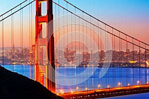 San Francisco Golden Gate Bridge sunrise through cables