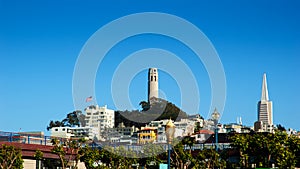 San Francisco Coit tower on Telegraph hill and Transamerica building with clear summer sky photo