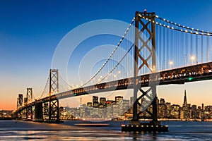 San Francisco skyline and Bay Bridge at sunset, California