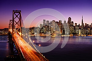 San Francisco skyline and Bay Bridge at sunset, California photo