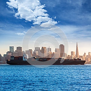 San francisco Skyline with merchant ship cruising bay at California