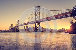 San Francisco skyline with Oakland Bay Bridge at sunset, California, USA