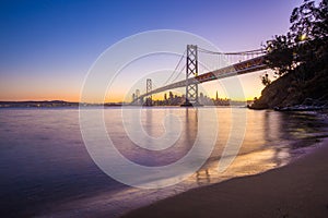 San Francisco skyline with Oakland Bay Bridge at sunset, California, USA