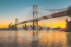 San Francisco skyline with Oakland Bay Bridge at sunset, California, USA