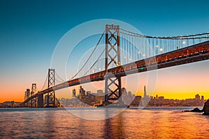 San Francisco skyline with Oakland Bay Bridge at sunset, California, USA