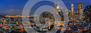 San Francisco skyline panorama at dusk with Bay Bridge and downtown skyline under a full moon