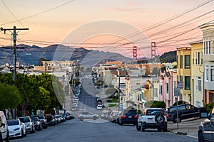 San Francisco Skyline with Residential Neighborhood, Crooked Street and The Golden Gate Bridge at Sunset