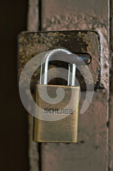 Schlage hardened weathered padlock holding a door closed